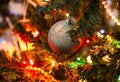 Silver ball and colorful lights on Christmas tree Royalty Free Stock Photo