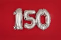 Silver 150 balloons on wine red matt background Royalty Free Stock Photo