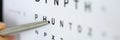 Silver ballpoint pen pointing to letter in eyesight check table