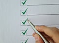 Silver ballpoint pen to cross off items from checklist Royalty Free Stock Photo