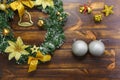 Silver balls, golden bells, Christmas wreath set on wooden texture Royalty Free Stock Photo