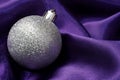 Silver bauble on purple cloth