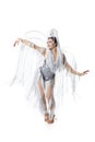 Beautiful young woman in carnival, stylish masquerade costume with feathers dancing on white studio background. Concept Royalty Free Stock Photo