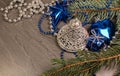 Silver bell with blue decoration and coniferous branch Royalty Free Stock Photo