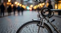 Bicycle parked on a cobblestone street with blurred city lights in the background bike Royalty Free Stock Photo