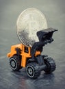 Bitcoin as virtual money and miniature excavator, mining cryptocurrency and international network payment concept Royalty Free Stock Photo