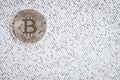 Silver Bitcoin on black and white binary 1 and 0 background