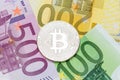Silver Bitcoin close-up. Euro currency as a background. Macro ph Royalty Free Stock Photo