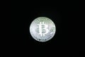 Silver bitcoin coin on black background