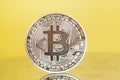 Silver Bitcoin coin on yellow . Electronic money Royalty Free Stock Photo