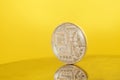 Silver Bitcoin coin on yellow . Electronic money Royalty Free Stock Photo