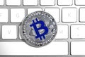 Silver bitcoin on computer keyboard. Digital currency Royalty Free Stock Photo