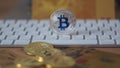 Silver bitcoin cymbol on keyboard. Selective focus.