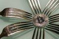 Silver bitcoin and silver forks around Royalty Free Stock Photo