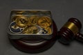 Bitcoins, litecoin and ethereum lies in metal box on old wooden background with judge gavel Royalty Free Stock Photo