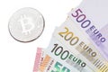 Silver Bitcoins close-up Bitcoin and euros on white background. Royalty Free Stock Photo