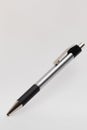A silver and black ballpoint pen is depicted on a light background. The pen Royalty Free Stock Photo