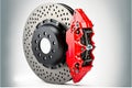 Silver black brake discs with red mount isolated on white background