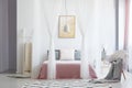 White chair in canopy bedroom Royalty Free Stock Photo