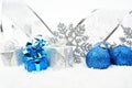 Silver,blue christmas baubles,gifts,snowflake with silver ribbon on snow Royalty Free Stock Photo