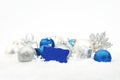 Silver and blue christmas decoration on snow with wishes card Royalty Free Stock Photo