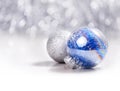 Silver and Blue Christmas ornaments balls on glitter bokeh background with space for text. Xmas and Happy New Year Royalty Free Stock Photo