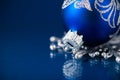 Silver and blue christmas ornaments on dark blue background with space for text. Merry christmas card. Royalty Free Stock Photo