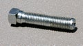 A silver bolt with a hexagonal head and threaded shaft. Royalty Free Stock Photo