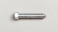 A silver bolt with a hexagonal head and threaded shaft. Royalty Free Stock Photo