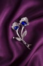 Silver brooch flower with blue stone on silk