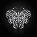 Silver butterfly with floral pattern.