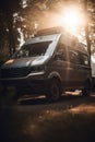 Silver camper van with sunlight and trees in forest created using generative ai technology Royalty Free Stock Photo