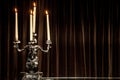 Silver candle holderwith candles lit on a table. Royalty Free Stock Photo
