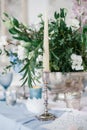 Silver candlestick as element of festive table wedding decorations. Royalty Free Stock Photo