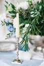 Silver candlestick as element of festive table wedding decorations. Royalty Free Stock Photo