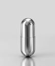 Silver capsule pill isolated on gray background. Clipping path included