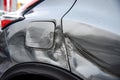 Silver car after the accident, broken door, fender and fuel tank close-up. Car accident close-up Royalty Free Stock Photo