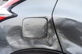 Silver car after the accident, broken door, fender and fuel tank close-up. Car accident close-up Royalty Free Stock Photo