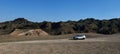 Silver car in the canyon, unusual texture of mountains, nature and technology concept, blue sky Royalty Free Stock Photo