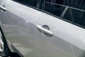 Silver car element car door handle. Silver car door with handle and splashes of water after car wash