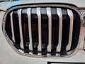 Silver car grille with black trim on the white car body Royalty Free Stock Photo