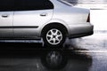 Silver car on parking in the rain