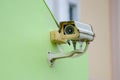 Silver CCTV Camera on the green wall Closed Circuit Television camera on green background Royalty Free Stock Photo