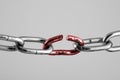 Silver chain with red broken link, concept of freedom.