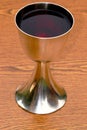 Silver chalice with red wine