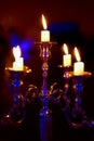 Silver chandelier and burning candles on decorated wedding table. Royalty Free Stock Photo