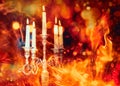 silver chandelier and burning candles and fire effect. Royalty Free Stock Photo