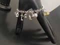 Silver charm bracelet with pendants on mannequin hand Royalty Free Stock Photo