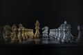 Silver chess knight is facing golden chess king on black background. Business strategy, market share, business competition, Royalty Free Stock Photo