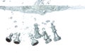 Silver Chess many Figure throw fall into clear water with air bubble. Unpredictable failure of business plan strategy and human Royalty Free Stock Photo